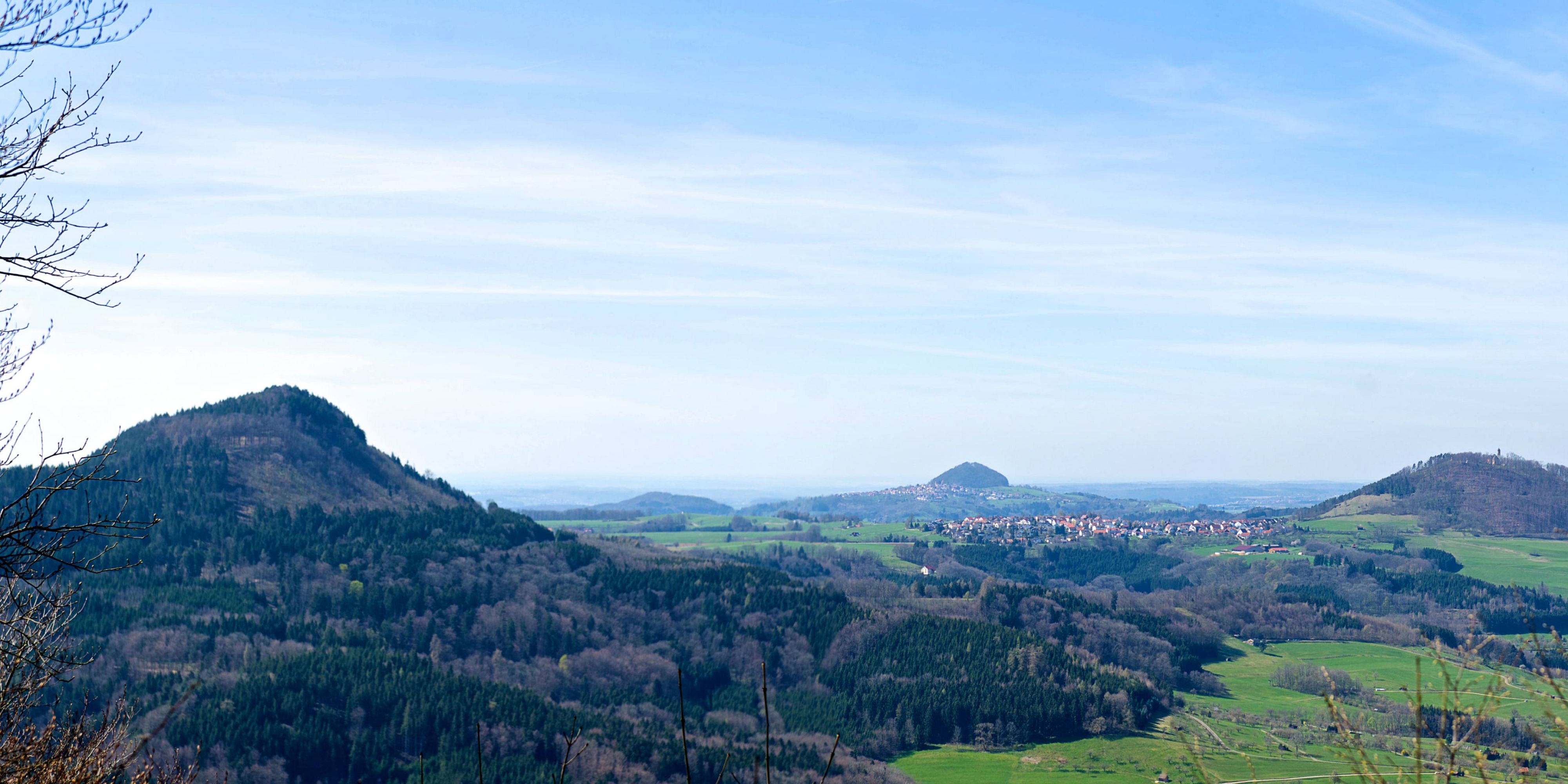 blick auf die drei kaiserberge, mit grünen feldern und bewaldeten hügeln bei göppingen